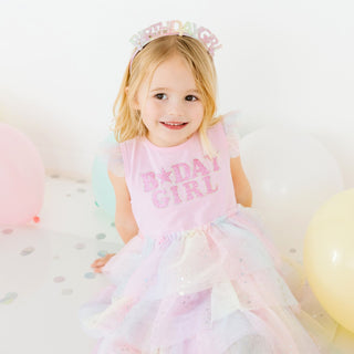 Sweet Wink birthday girl fairy dust tutu dress with short sleeves and pastel rainbow colors worn by a model.