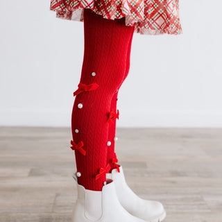 Sweet Wink Bedazzled Coquette Tights - Ruby Red
Red leg warmers with decorative bows and pearls worn by a child on a wooden floor.