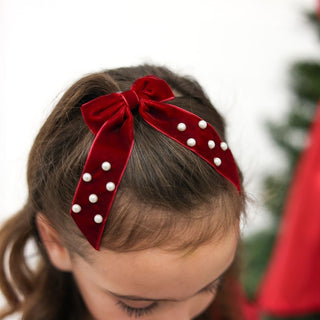 Sweet Wink Ruby Red Velvet Coquette Bow Clip
Red velvet bow with white pearls on a blurred background