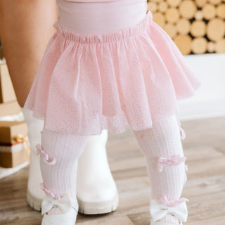 Sweet Wink blush velvet bow tights on a model, featuring a cozy, festive design with a velvet bow detail for holiday wear.