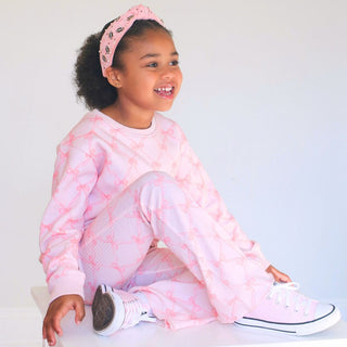 Sweet Wink Bow Trellis Sweatshirt & Flare Legging Set
Young girl wearing a pink tie-dye outfit with a matching headband on a white background