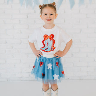 Sweet Wink patriotic cutie tutu with red glitter bow, worn with a short sleeve cowgirl patch t-shirt on a model.