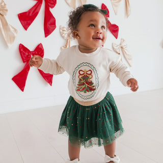 Sweet Wink Christmas tree sequin patch sweatshirt on a model, featuring long sleeves, festive embellishments, and matching holiday accessories.