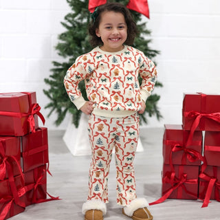 Sweet Wink Christmas Cutie Sweatshirt & Flare Legging Set
Child wearing a Christmas-themed outfit with red gifts and a tree in the background