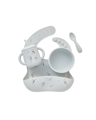 Mushie x Quincy Mae Space-themed feeding set with bowl, plate, cup, and utensils for young children, featuring colorful space designs.