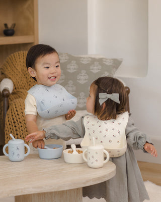 Mushie x Quincy Mae Space feeding set with a plate, bowl, cup, and utensils featuring space-themed designs for babies.