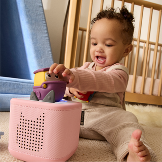 Tonies Character - My First Tonies: Transportation Set
Child playing with a pink toy box and purple toy in a crib