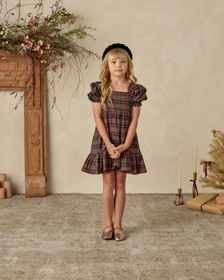 Noralee Louella Dress - Winter Tartan
Young girl in a plaid dress standing in a room with decorative elements.