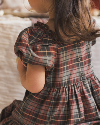 Noralee Louella Dress - Winter Tartan
Child wearing a plaid dress with a blurred background