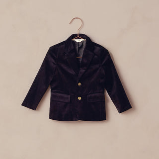 Noralee Sebastian Blazer - Black
Black blazer on a hanger against a beige background