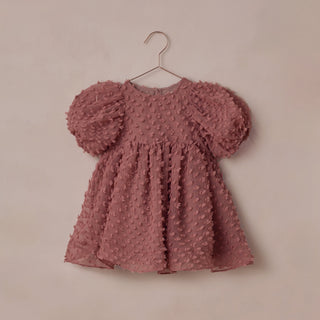 Noralee Luna Dress - Raspberry
Pink textured dress on a hanger against a beige background