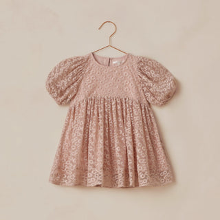 Noralee Luna Dress - Rose Embroidered Daisy
Pink floral dress on a hanger against a beige background