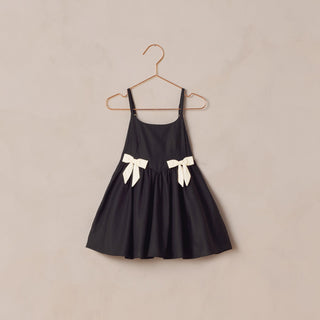 Noralee Betsy Dress - Black
Black dress with white bows on a beige background