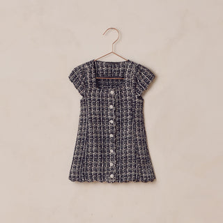 Noralee Gabrielle Dress - Black
Black and white checkered dress on a hanger against a beige background