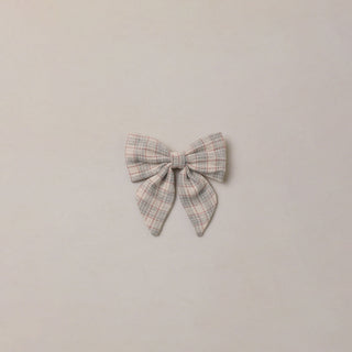 Noralee Norah Bow - Fall Plaid
A small fabric bow with a light beige, gray, and white plaid pattern, centered on a plain, warm off-white background.