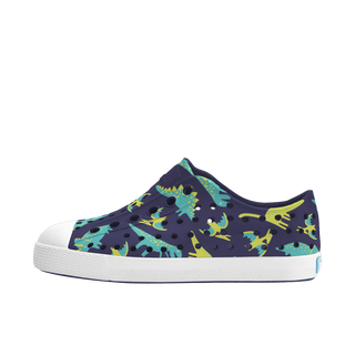 Native Jefferson Print Shoes - Regatta Blue / Shell White / Trinket Dinosaurs
Navy blue sneaker with dinosaur pattern on a white background