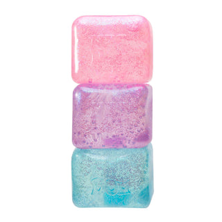 NeeDoh Glitter & Glow Nice Cube
Three glittery nail polish bottles stacked on a white background
