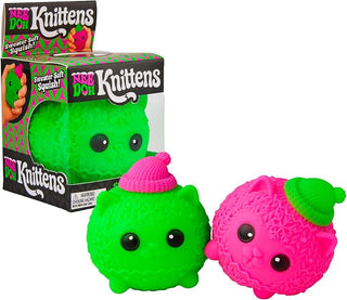 NeeDoh Squishmas Knittens
Two small squishy toys from Need Do Knittens shown in front of their retail box on a white background. One toy is bright green with a pink knit hat, and the other is bright pink with a green knit hat.