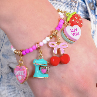Charm It! Gold Cherries Charm
Colorful bracelet with various charms on a wrist against a denim background