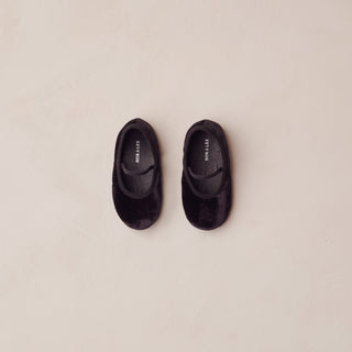 Noralee Baby Ballet Flats - Black
Pair of black shoes on a beige background