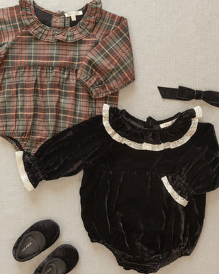 Noralee Baby Ballet Flats - Black
Plaid baby romper and black velvet romper with decorative collar on a neutral background