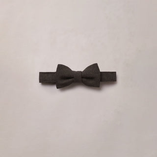 Noralee Bow Tie - Black
A dark gray textured bow tie laid flat on a light beige background.