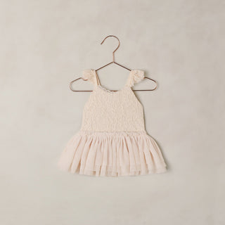 Noralee Camilla Tutu - Pearl 
Pink lace dress on a hanger against a beige background