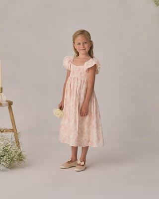 Noralee Hazel Dress - Blush English Rose
Young girl in a pink dress standing against a plain background