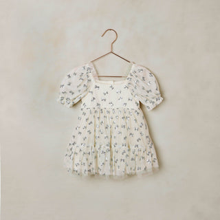 Noralee Louella Dress - Bows
Floral dress on a hanger against a beige wall
