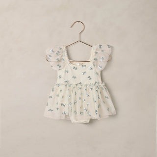 Noralee Margot Romper - Bows
Floral baby romper on a hanger against a beige background