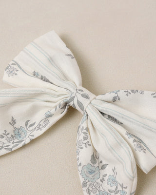 Noralee Norah Bow - French Floral Stripe
Floral-patterned fabric bow on a beige background