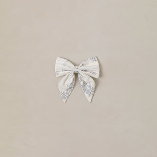 Noralee Norah Bow - French Floral Stripe
White bow with floral pattern on a beige background