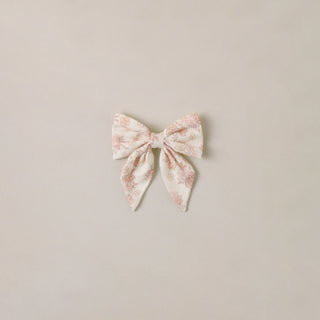 Noralee Norah Bow - Ivory
Floral bow hair accessory on a beige background