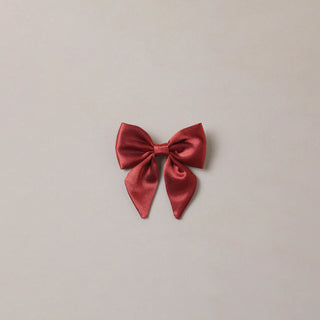 Noralee Norah Bow - Ruby
Red bow on a beige background