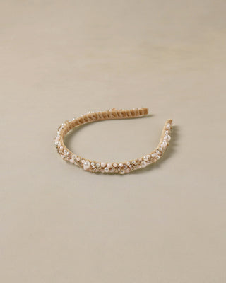 Noralee Pearl Headband - Ivory
Gold headband with pearls on a beige background