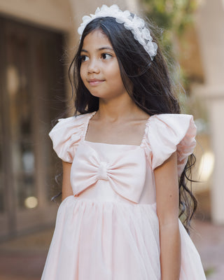 Noralee blush Pixie headband with soft fabric and delicate design, styled on a model for a casual, elegant look.