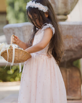 Noralee blush pixie headband with soft, fabric design, shown on a model as a stylish hair accessory.