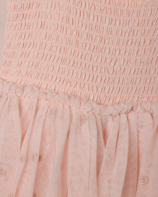 Noralee Poppy Dress - Blush
Close-up of a pink textured fabric with smocked top and layered skirt.