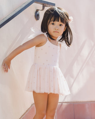 Noralee Poppy Tutu - Blush
Young girl in a white dress standing on a staircase