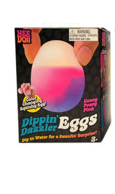 Nosey Poey Pink 
NeeDoh Dippin Dazzler
Three boxes of Dippin' Dazzler Eggs with colorful egg-shaped objects on a white background.