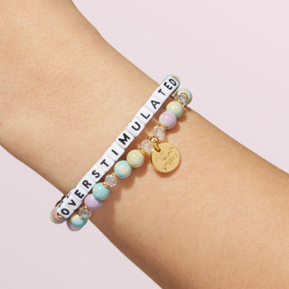 Little Words Project bracelet featuring the "Overstimulated" charm, showcasing a stylish and meaningful jewelry piece with delicate design.