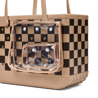 Original Bogg® Bag - Checkered: Camel / Hot Cocoa
A beige and black checkered tote bag with clear plastic zippered pockets and tan handles, shown on a white background.
