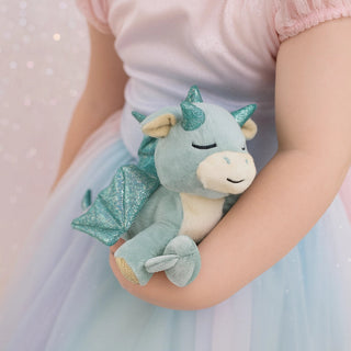 Olli Ella Binky Dragon - Volt
Child holding a plush dragon toy with glittery accents