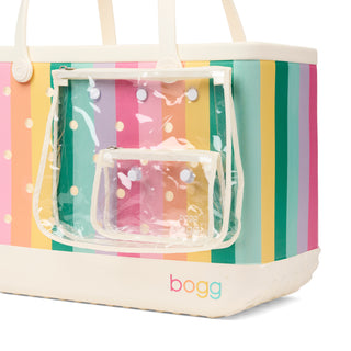 Original Bogg® Bag - Liquid Sunshine - Color Burst
Colorful striped bag with a clear pouch featuring polka dots, branded 'bogg'.