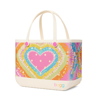 Original Bogg® Bag - Liquid Sunshine - Taffy 
Colorful tote bag with a heart design on a white background