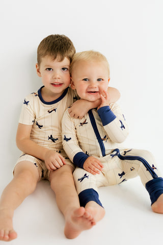In My Jammers Airplane
Two children in matching pajamas sitting on a white background