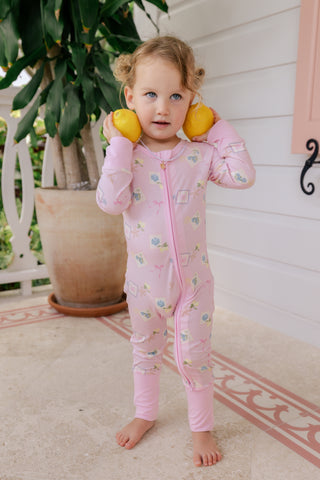 In My Jammers Zipper Romper pajamas featuring a coastal notes print with a front zipper, displayed on a hanger.