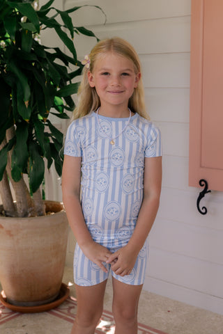 In My Jammers floral seashell two-piece pajama set featuring a short sleeve top and matching shorts with a colorful seashell pattern.