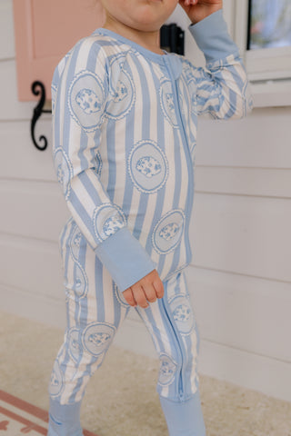 In My Jammers floral seashell zipper romper pajamas laid flat, showcasing the colorful floral pattern and zipper closure.