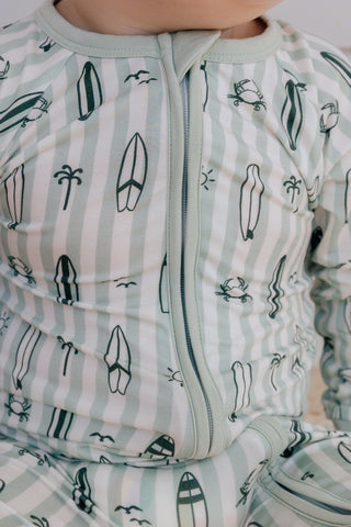 In My Jammers green zipper romper pajamas with surf-inspired print, featuring a front zipper and relaxed fit.